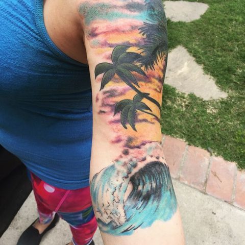 arm waves beach scene tattoo