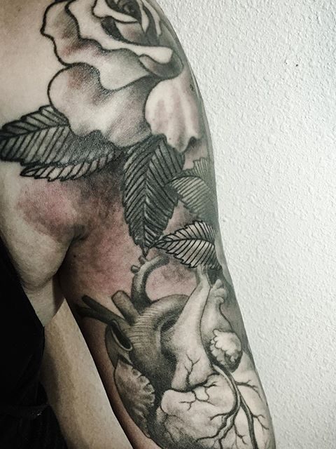 heart and flowers arm tattoo