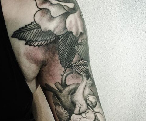heart and flowers arm tattoo