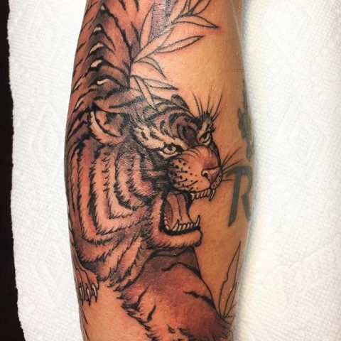 black and gray tiger arm tattoo