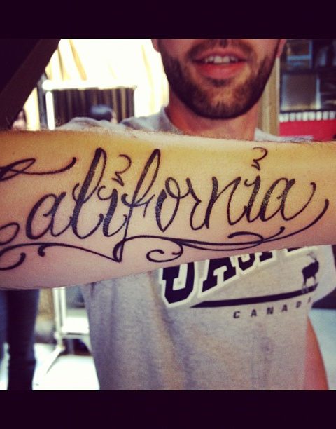 California script tattoo