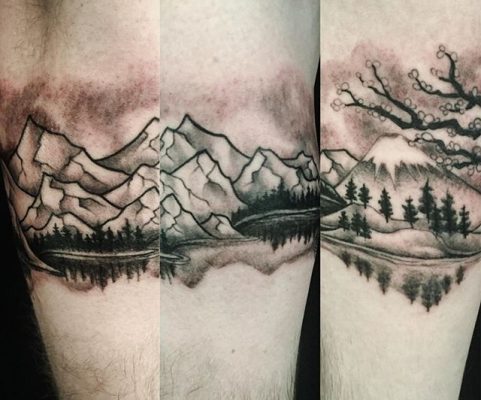 mountains on arm tattoo