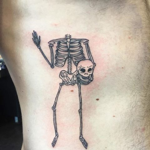 skeleton holding head tattoo