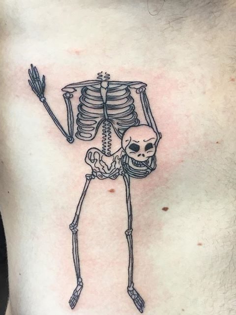 skeleton holding head tattoo